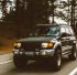 timelapse photography of green SUV on road