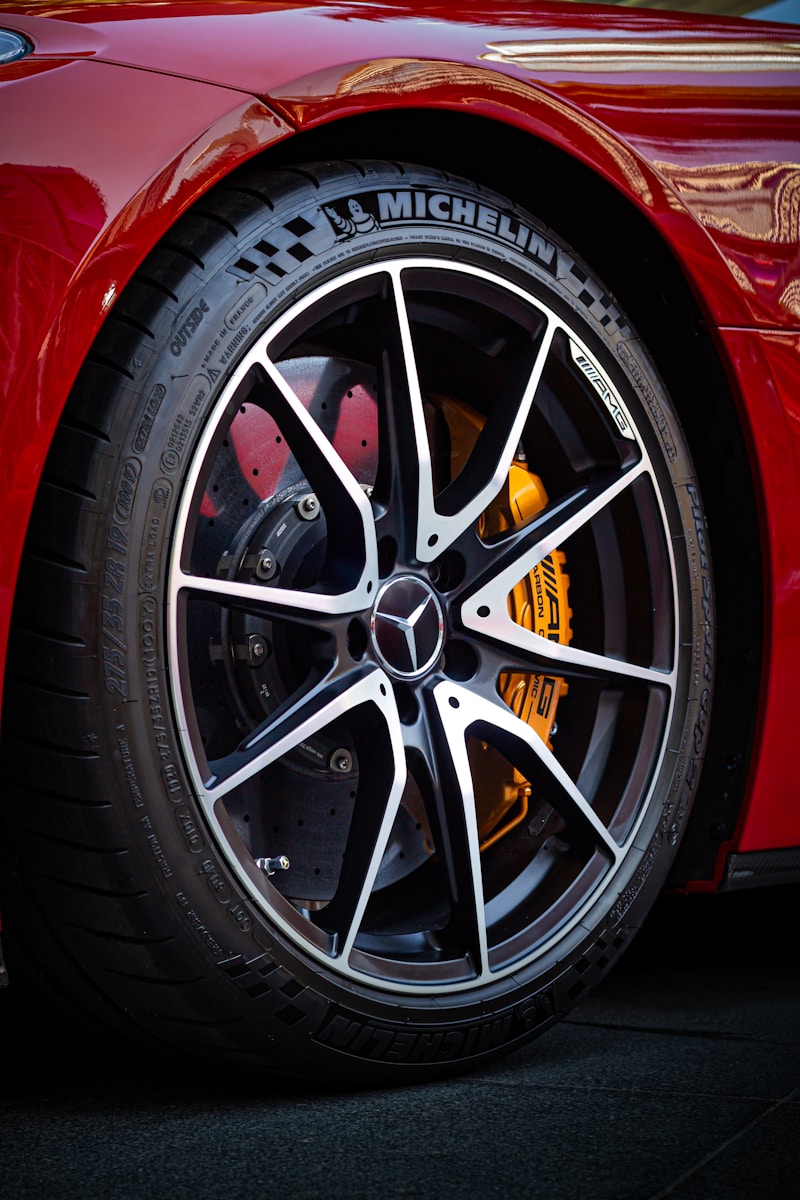 a close up of a tire on a red sports car