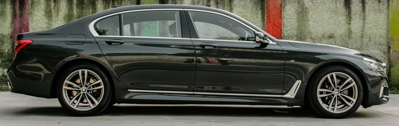 a black car parked in front of a building